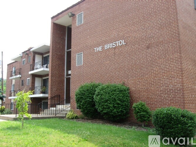 The Bristol building has a green lawn in front of it.