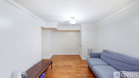 A living room with a grey couch and a wooden bench.