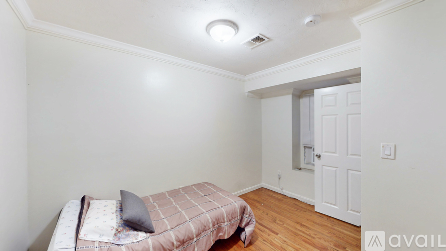 A bedroom with a bed and a door.