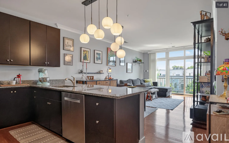 A modern kitchen with dark brown cabinets and a central island.