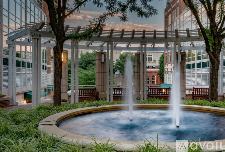 A pool with a fountain in the middle of it.