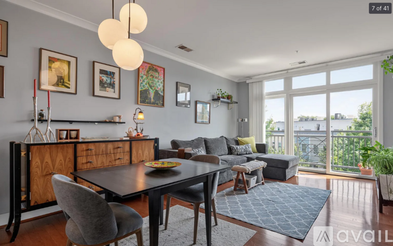 A dining room with a black table and chairs.