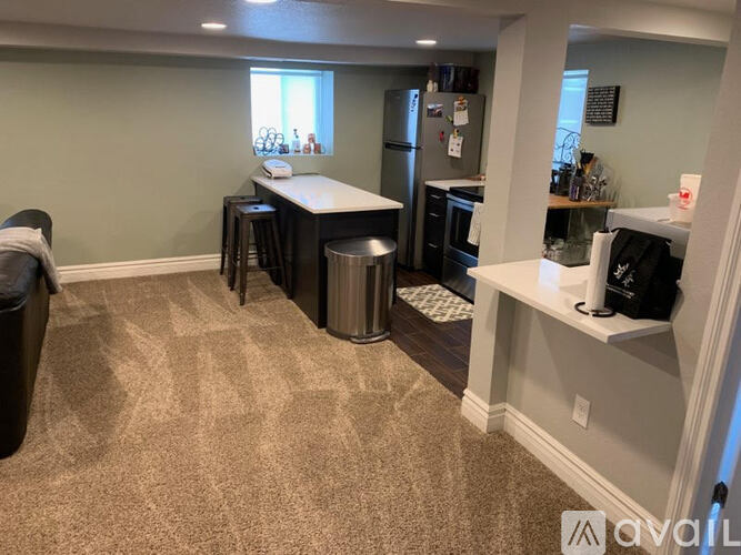 A kitchen with a counter and a fridge.