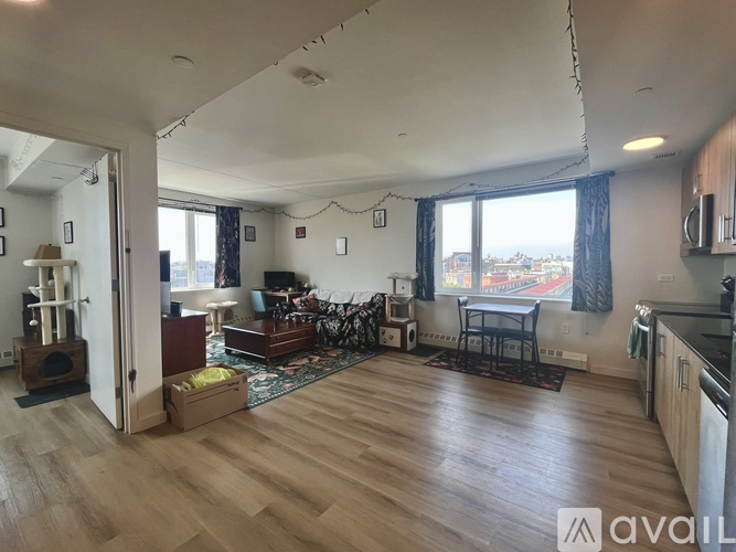 A living room with a couch, a chair, a table, and a bicycle.