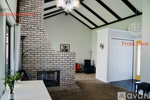 A living room with a fireplace and a white table.