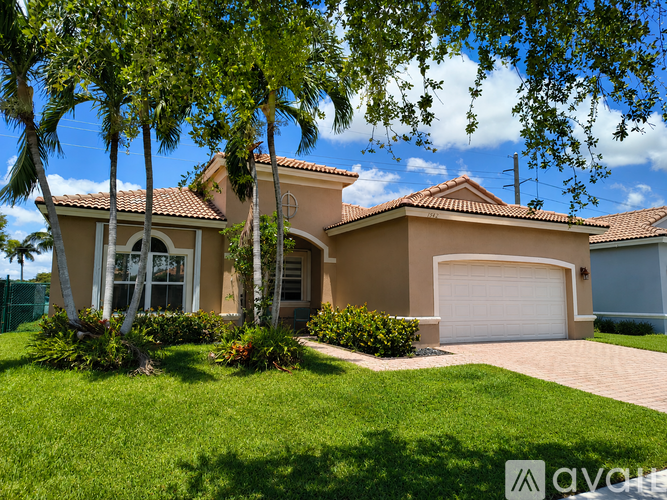 A house with a white garage door and a brown roof.