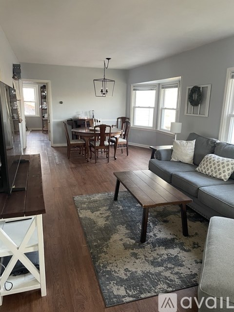 A living room with a grey couch and a wooden coffee table.