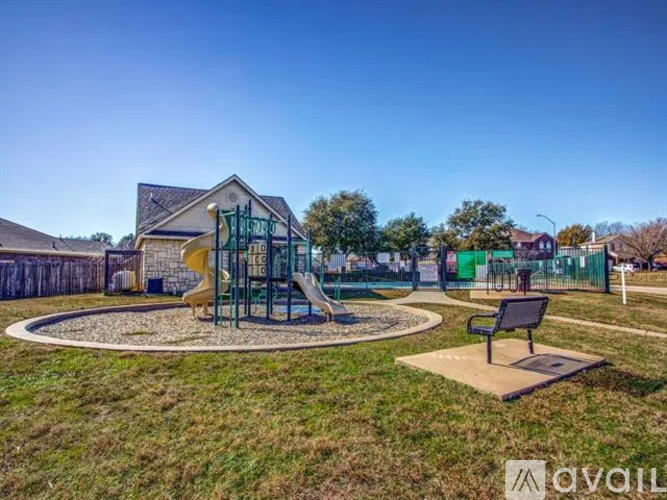 A playground with a slide and a swing set.