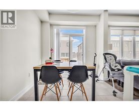 A dining room with a table and chairs.