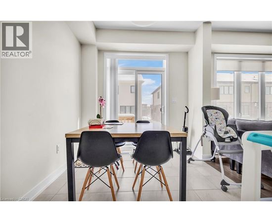 A dining room with a table and chairs.