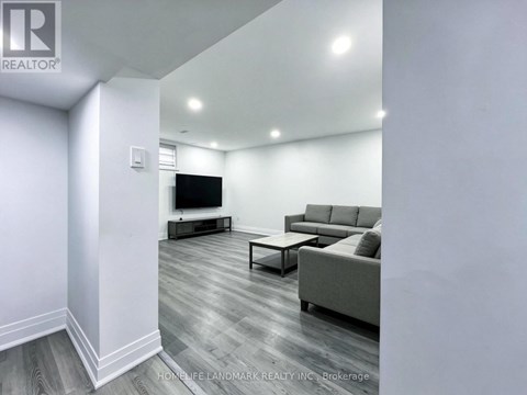 A living room with a grey couch and a television.