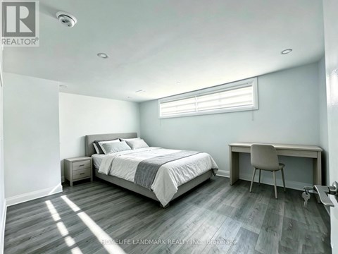 A bedroom with a bed, desk, and chair.