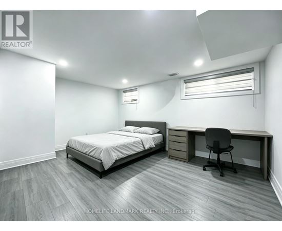 A bedroom with a bed, desk, and chair.