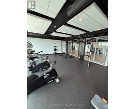 A gym with a variety of equipment including treadmills, weights, and exercise machines.