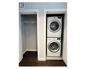 A washing machine is sitting in a small laundry room.