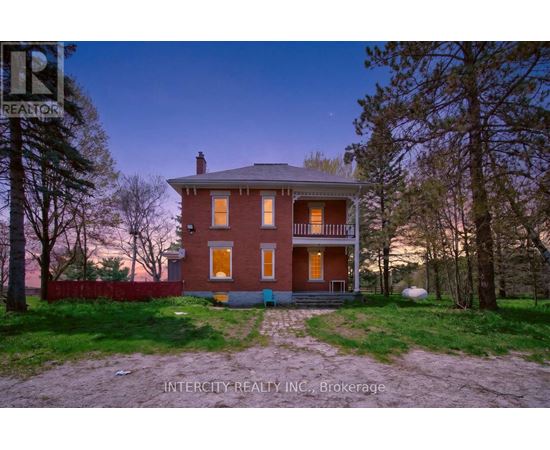 A house with a red brick exterior and a white porch.