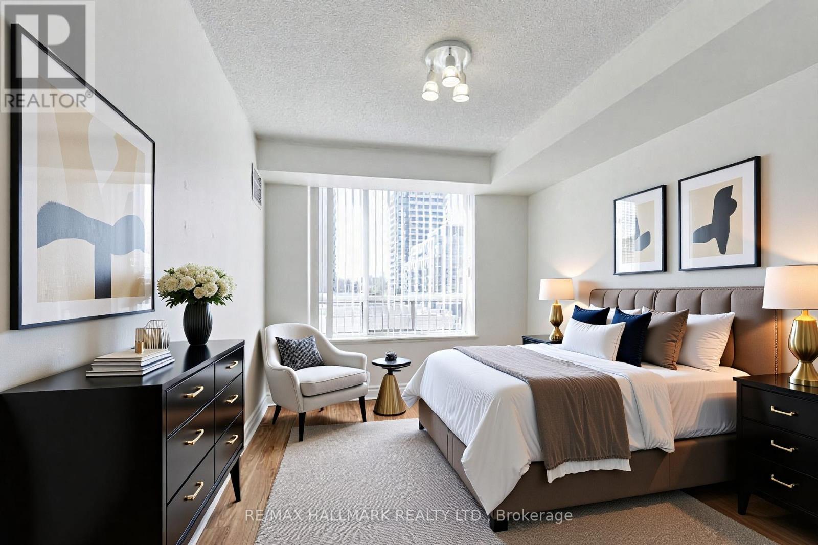 A bedroom with a large bed, a chair, and a dresser.