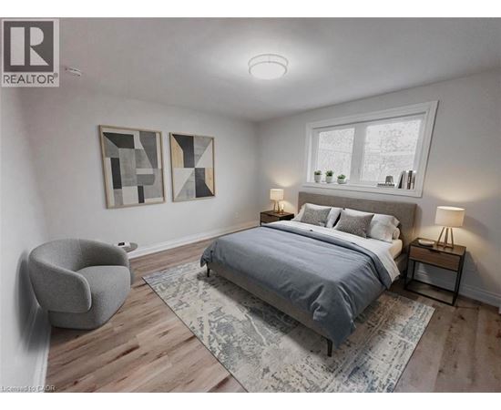 A bedroom with a bed, chair, and two lamps.