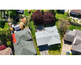 A bird's eye view of a neighborhood with houses and trees.