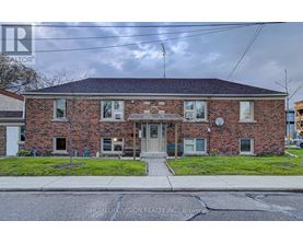 A brick house with a sign that says HomeLemision Realty Inc. Brokers.