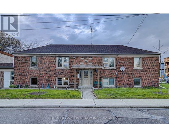 A brick house with a sign that says HomeLemision Realty Inc. Brokers.