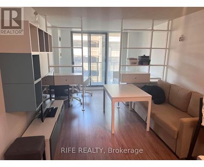 A modern living room with a dining table and chairs.