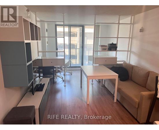 A modern living room with a dining table and chairs.
