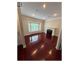 A room with a fireplace and a window.