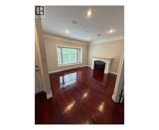 A room with a fireplace and a window.
