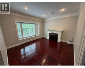 A living room with a fireplace and a large window.