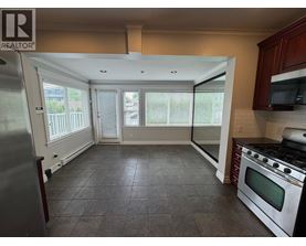 A kitchen with a refrigerator, oven, and microwave.