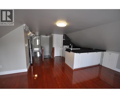 A room with wooden floors and white walls.
