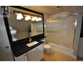 A bathroom with a sink, toilet, and shower.