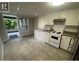A kitchen with white appliances and cabinets.