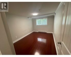A room with wooden floors and white walls.