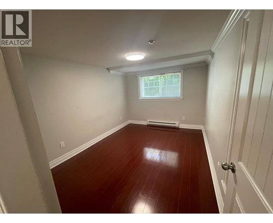 A room with wooden floors and white walls.