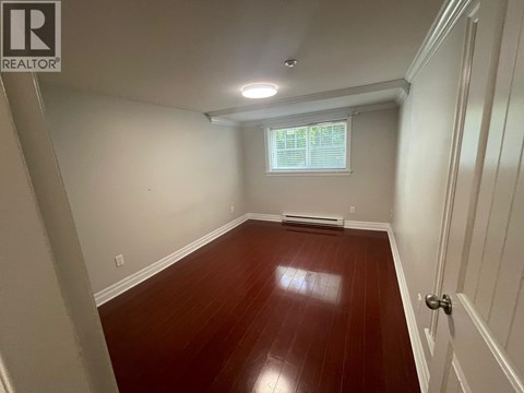 A room with wooden floors and white walls.