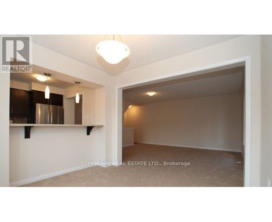 A spacious room with a large open doorway leading to another room.