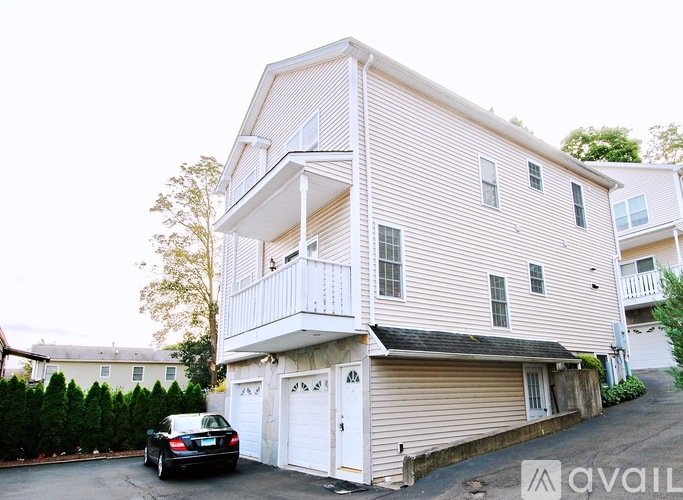 A two-story house with a balcony on the second floor.
