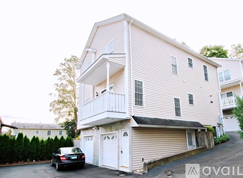 A two-story house with a balcony on the second floor.