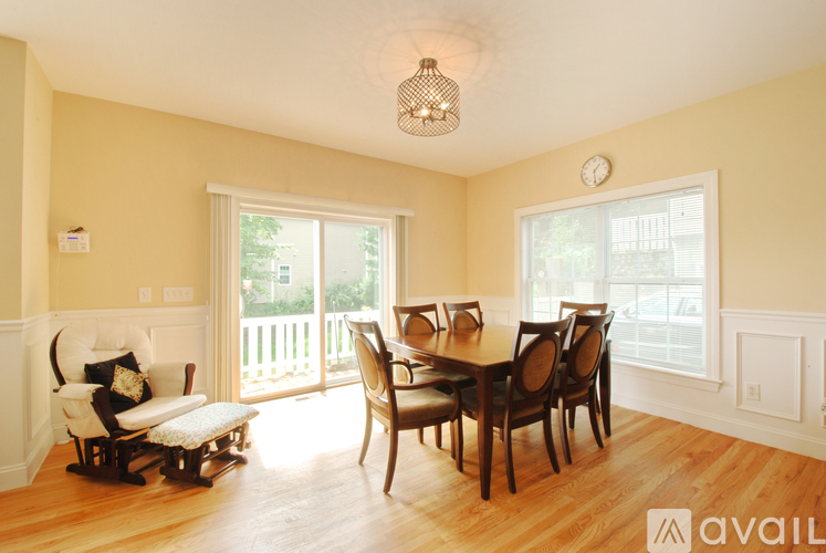 A dining room with a wooden table and chairs.