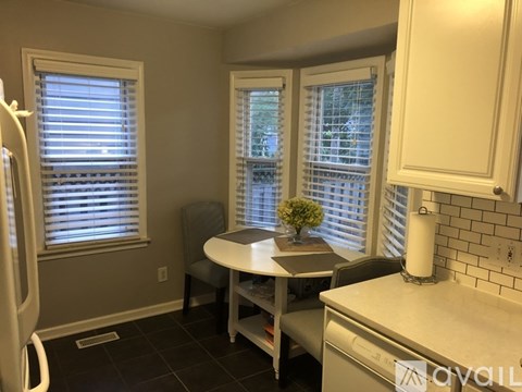 A small kitchen with a table and chairs.
