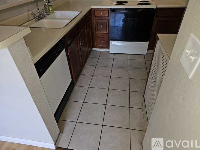 A kitchen with a black oven and white appliances.