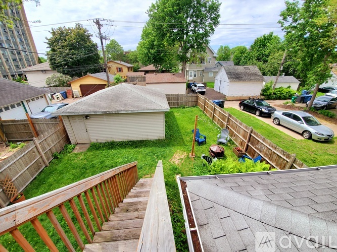 A backyard with a wooden deck and a fence.