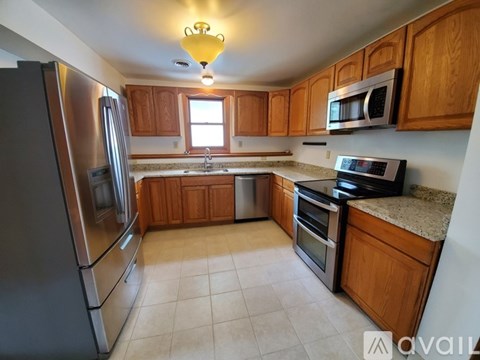 A kitchen with wooden cabinets and stainless steel appliances.