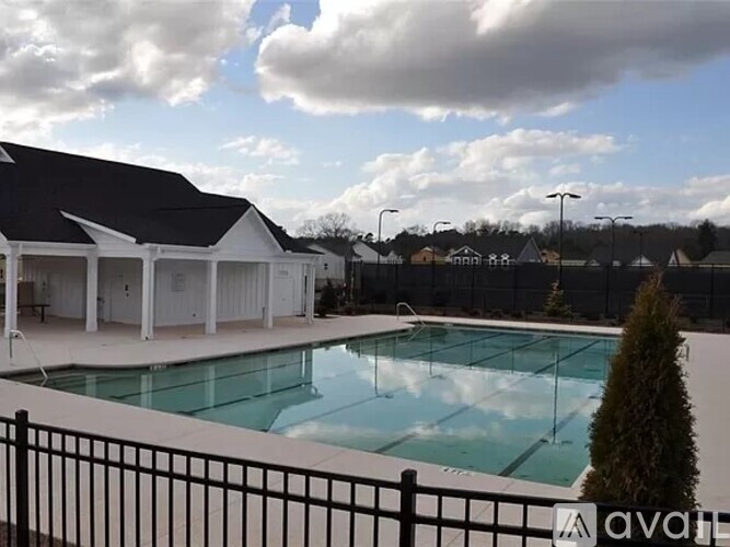 A large white house with a pool in the backyard.