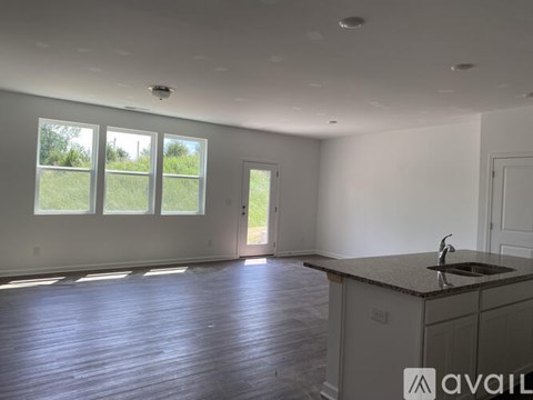 A spacious kitchen with a sink and a window.