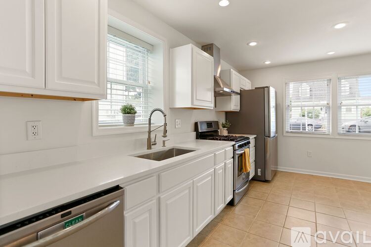 A kitchen with white cabinets and stainless steel appliances.