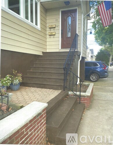 A house numbered 95 with a flag on the front.