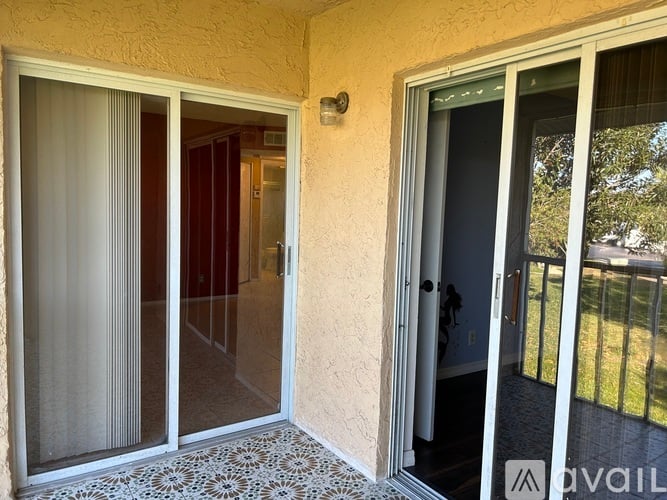 A room with a sliding glass door and a patterned floor.
